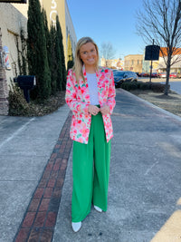 Blazer features a fun pink and white floral detail, long sleeves, collared detail, functional pockets, underlining detail, shoulder pads and runs true to size!