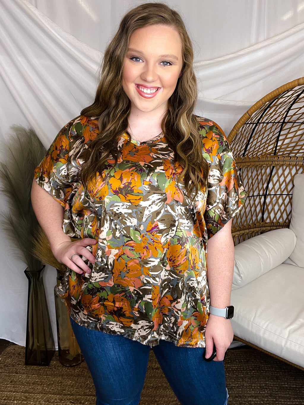 Top features V-neck detail, short cuffed sleeves, pumpkin color print, frayed bottom, and runs true to size!