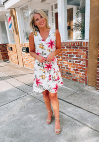 Dress features a simple ivory base, multi colored floral print, sleeveless detail, classic V-neck line, front tie wrap detail and runs true to size! 