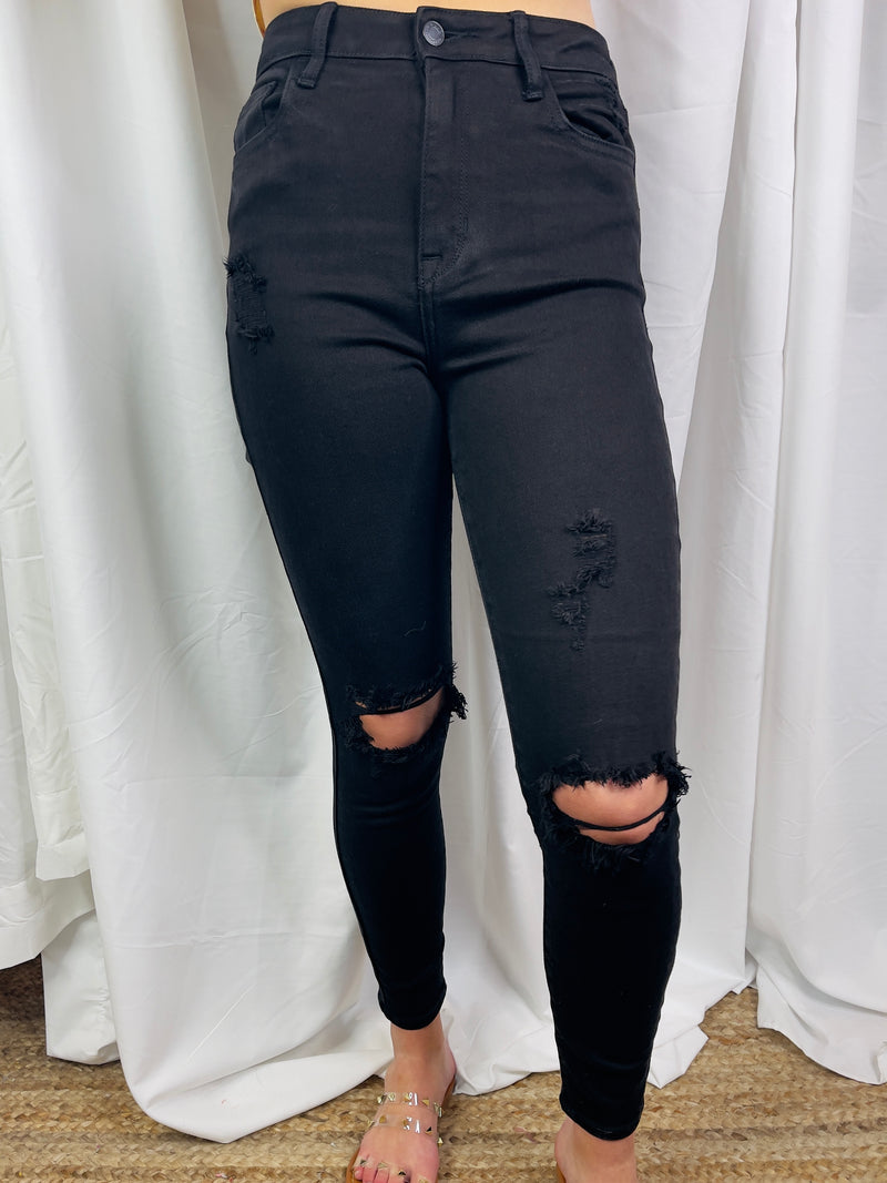 Jeans feature a jet black color, front distressing, skinny leg fit, high waist line and runs true to size! 