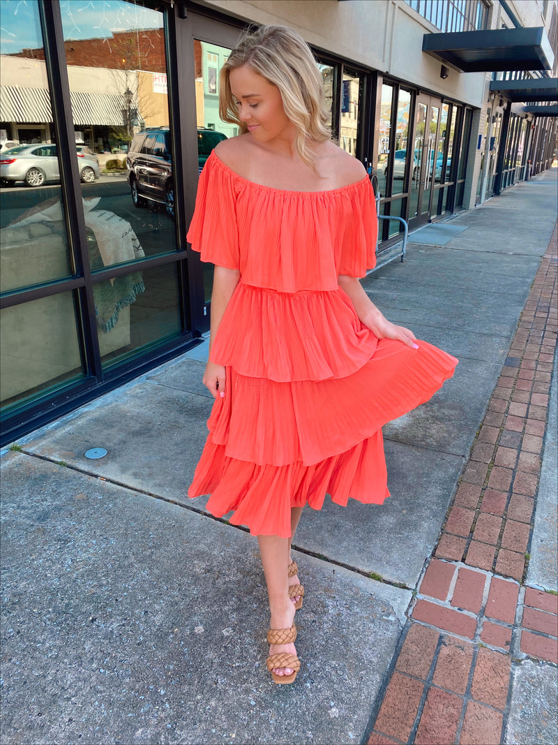 Dress features a coral color, layered detailing, off/on shoulder detail, underlining, midi length and runs true to size! 