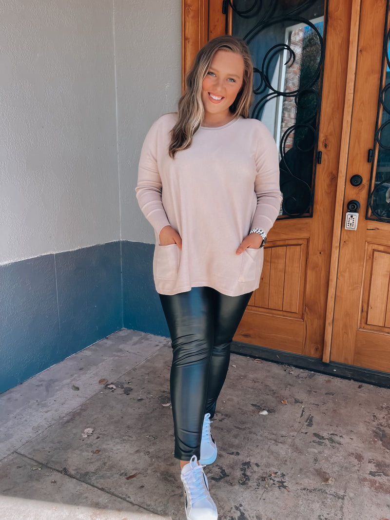 Top features a solid base color, long sleeves, front pocket detail, round neck line, cozy material and runs true to size! -taupe