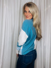 Top features a color block detail, long sleeves, soft material, round neck line, comfortable fit and runs true to size-blue