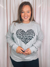 Graphic features a grey colored tee, black leopard heart design, long sleeves, round neck line, unisex fit and runs true to size! 