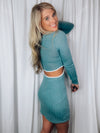 Dress features a teal base, cream outlining detail, cut out side detailing, soft ribbed material, long sleeves, round neck line and runs true to size! 