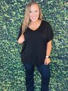 Solid short sleeve oversized V-neck tee with side slit details.  • Short sleeves, V-neck • Oversized silhouette • Side slit accents • Soft and stretchy • Pullover styling • Style with leggings or jeans for an effortless look • Soft and stretchy   - Approximately 25" L - 95% Rayon, 5% Spandex-BLACK