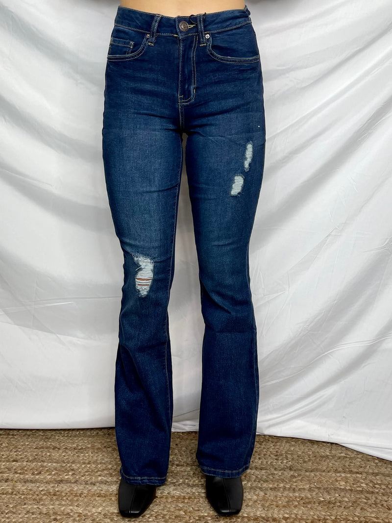 Jeans feature a dark wash denim, small distressing detailing, functional pockets, belt loops, zipper and button closure, flare bottom, 34 