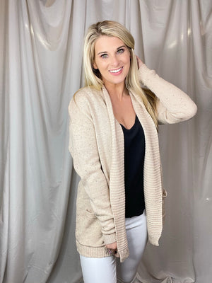 Cardigan features an oatmeal base, heathered detail, open front, long sleeveless light weight material and runs true to size! 