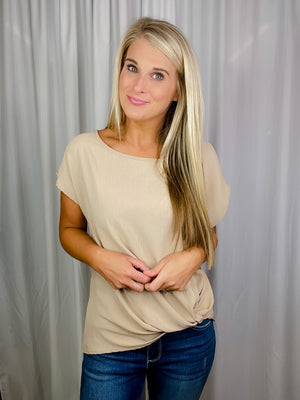 Top features a solid base color, short sleeves, round neck line, front knot detail, and runs true to size! -stone