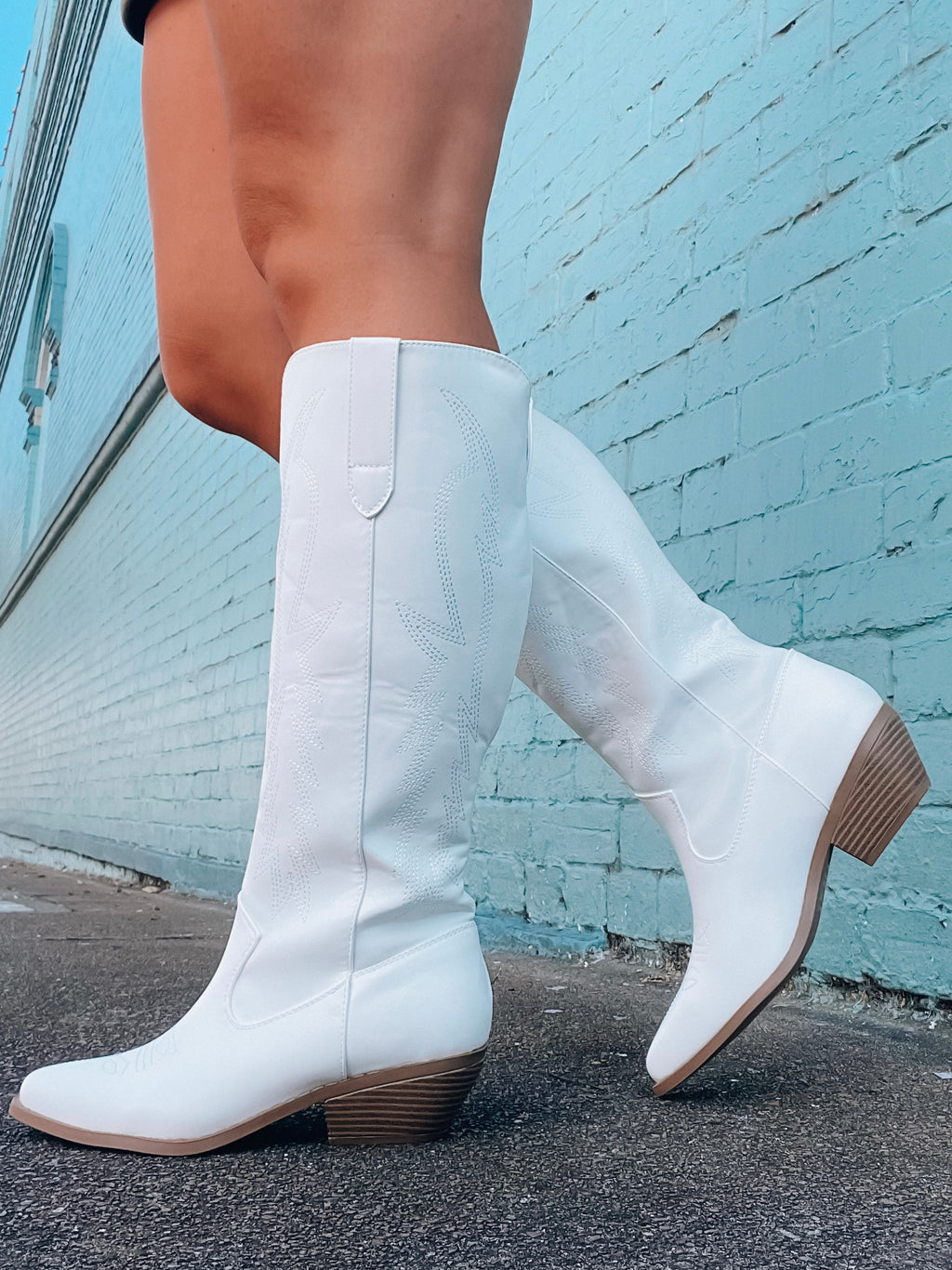 Boots feature a white leather material, light brown detailing, knee height, slip on detail and runs true to size!