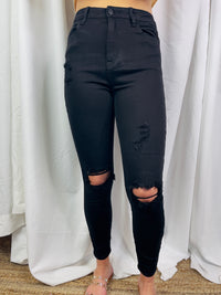 Jeans feature a jet black color, front distressing, skinny leg fit, high waist line and runs true to size! 