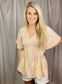 Peach floral top features a flutter short sleeve design with a smocked V-line chest, looking oh so flattering on. Runs true to size.