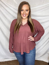Top features a marsala colored base, long sleeves, light weight material, V-neck line and runs true to size! 