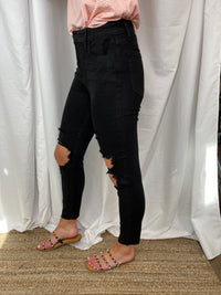 Fitted through the hip and more relaxed through the thigh & knee, our mom skinny jean offers a fit that’s as flattering as it is comfortable. Inspired by the 90s, this jet black wash style with big cutouts along with frayed hem detail gives your look an authentic, vintage vibe.   Inseam: 27"  Rise: 11"