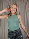 Bodysuit features a solid base color, thick comfy material, round neck line, sleeveless detail, fitted fit, and runs true to size!-green