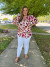 Top features an ivory base, multi colored floral print, short sleeves, V-neck line and runs true to size! 