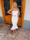 Dress features a solid base color, strapless detail, high-low hem line, front tie bow, mermaid fit and runs true to size! -white