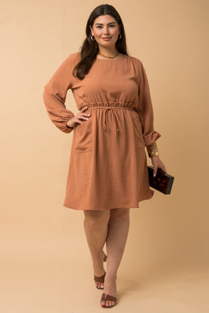 Dress features a solid camel color, long sleeve, front side pocket detail, paper bag waist band and runs true to size! 