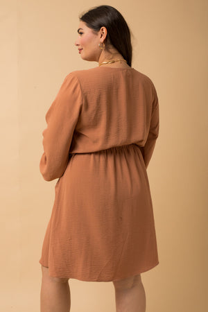 Dress features a solid camel color, long sleeve, front side pocket detail, paper bag waist band and runs true to size! 